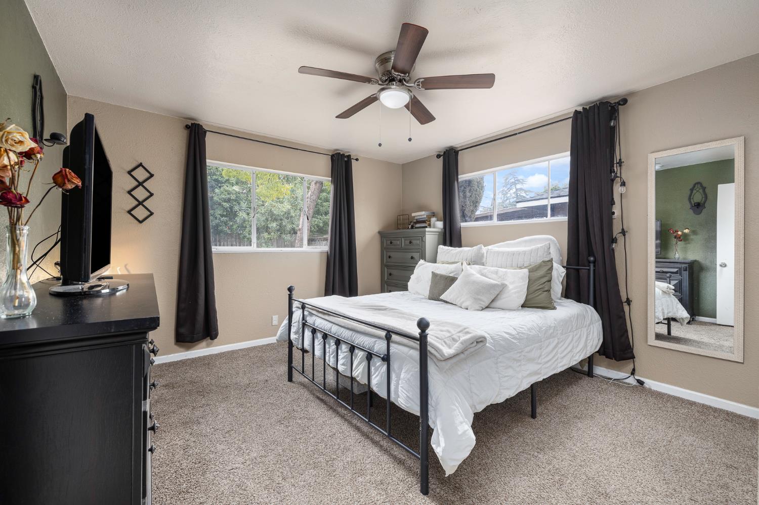 3310 East Hampton Way Fresno, CA 93726 - Photo 15 of 20 a bedroom with a bed window and a flat tv screen