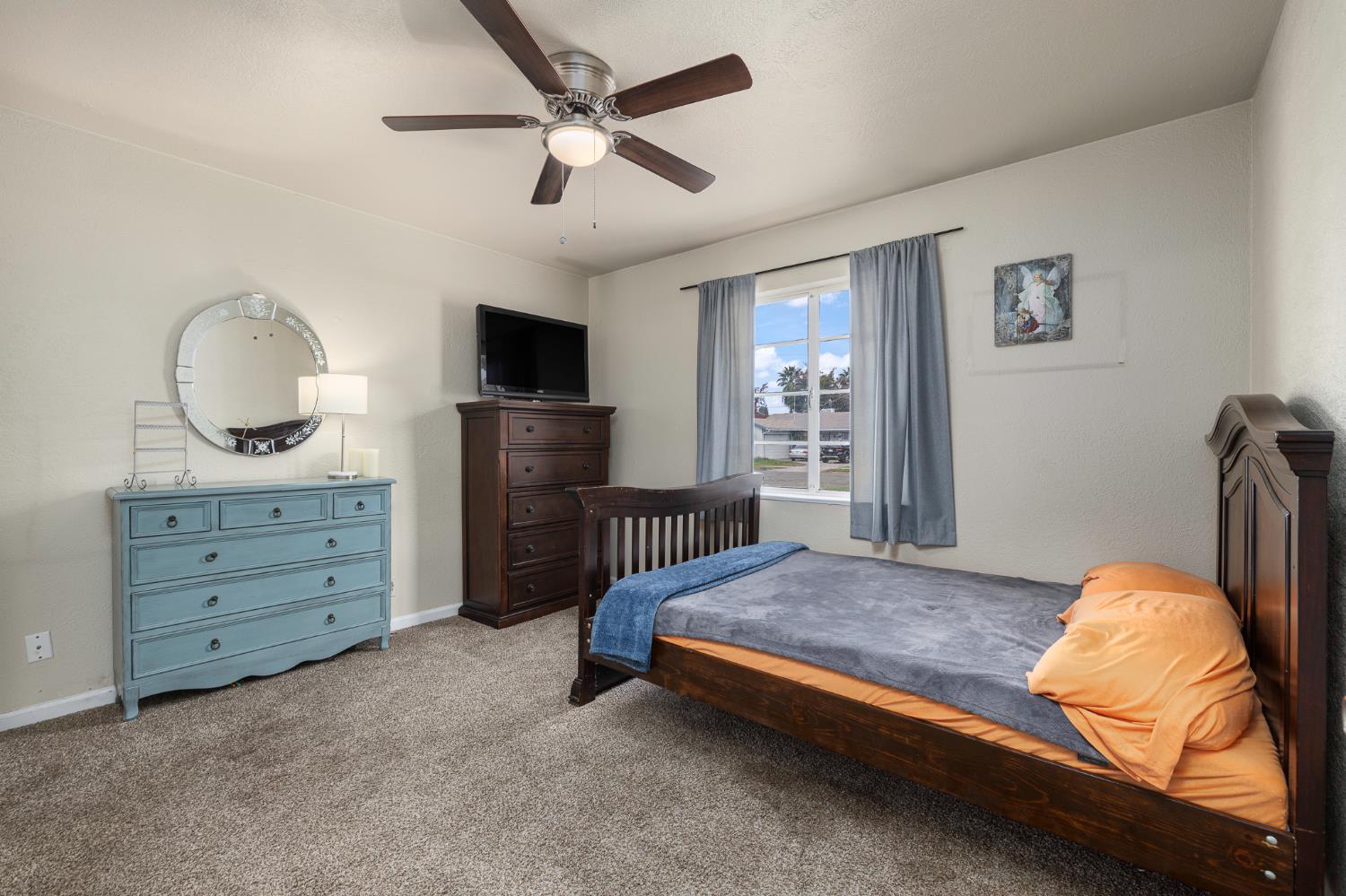 3310 East Hampton Way Fresno, CA 93726 - Photo 16 of 20 a bedroom with a bed closet and flat tv screen