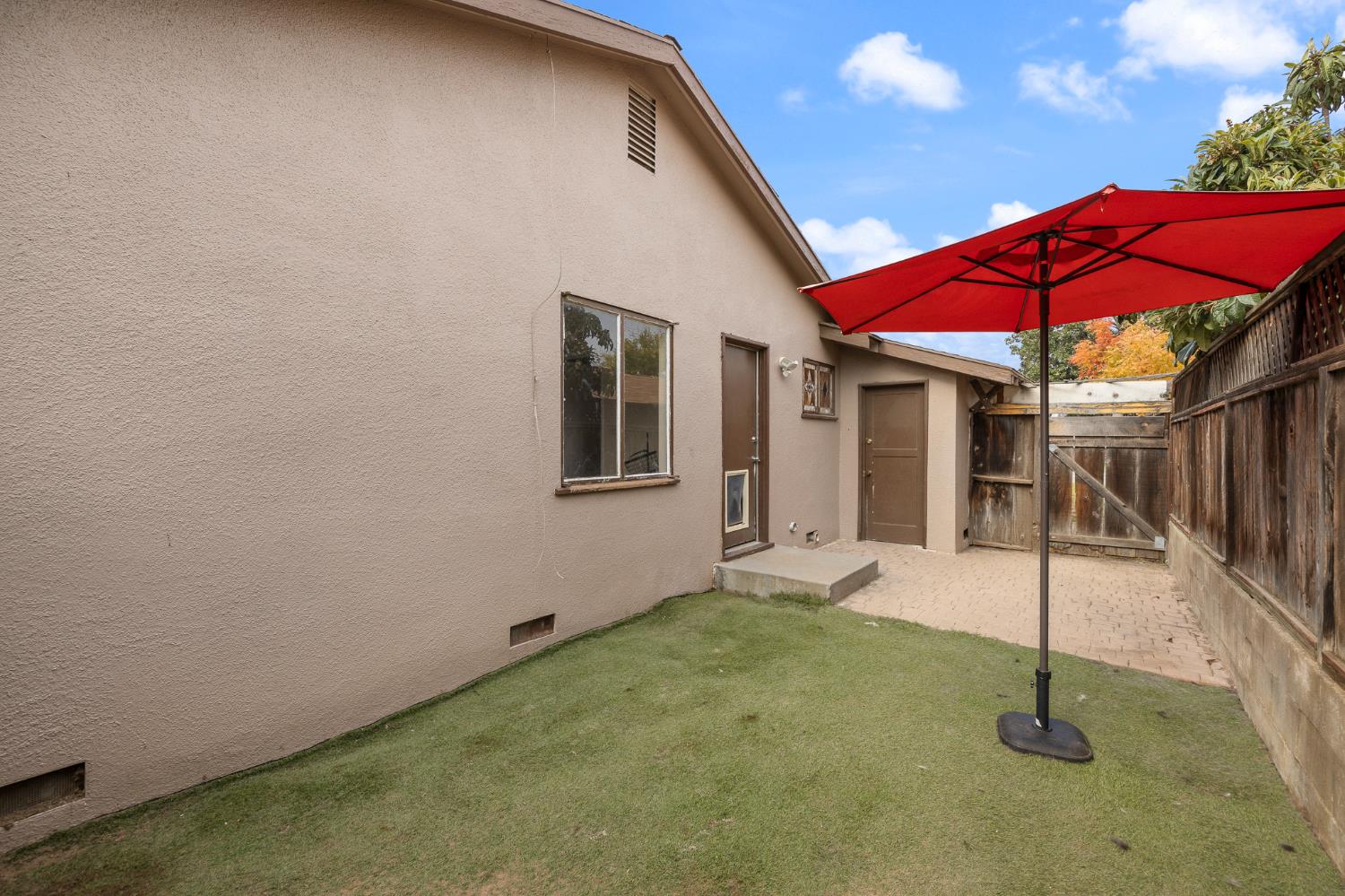 3310 East Hampton Way Fresno, CA 93726 - Photo 20 of 20 a view of a house with backyard and a patio