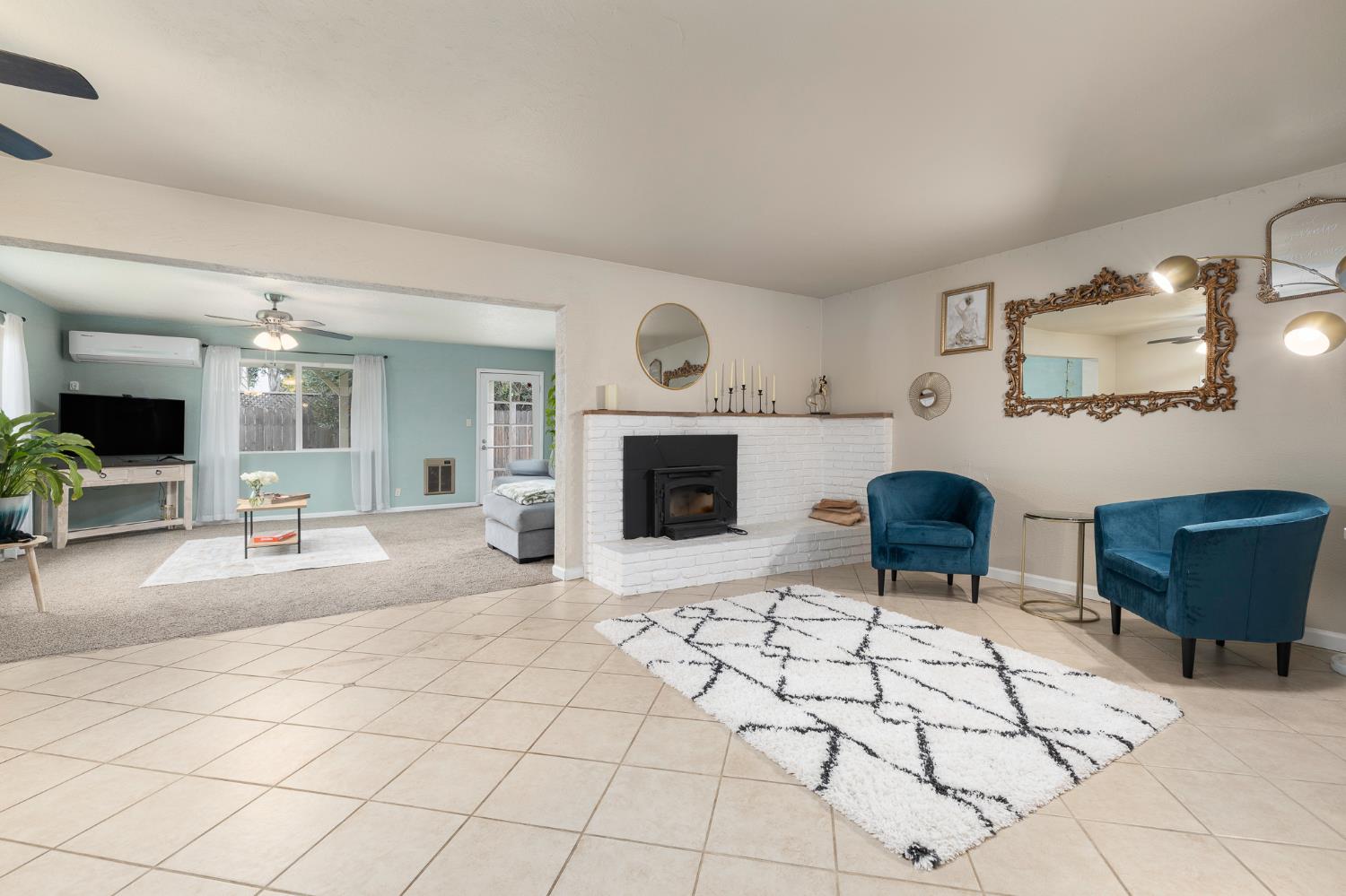 3310 East Hampton Way Fresno, CA 93726 - Photo 3 of 20 a living room with furniture a fireplace and a table