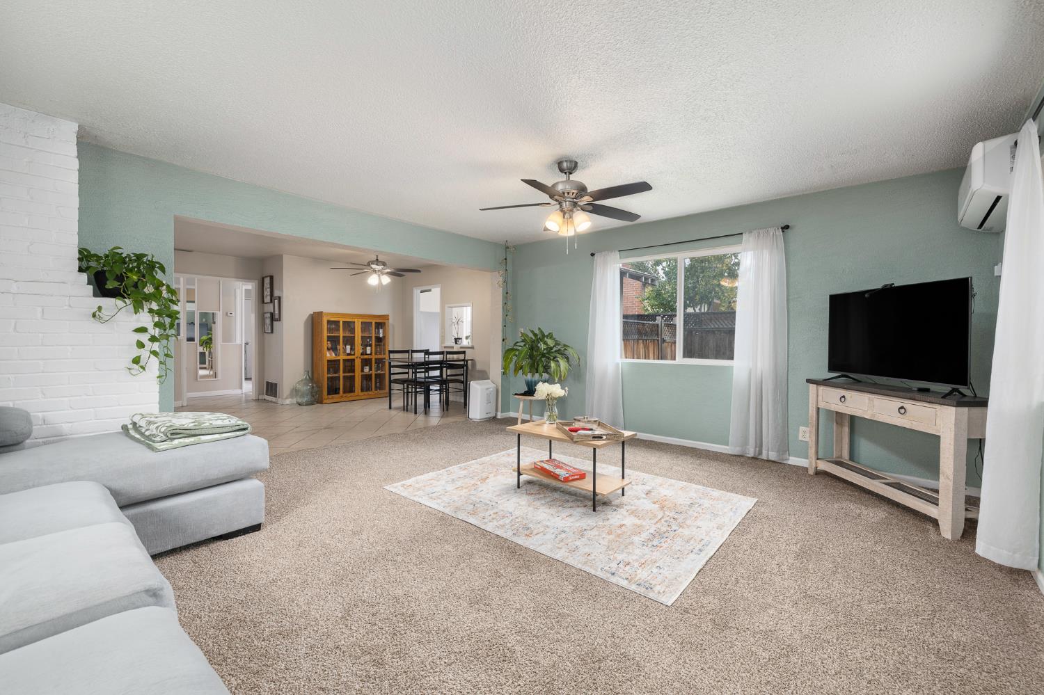 3310 East Hampton Way Fresno, CA 93726 - Photo 5 of 20 a living room with furniture and a flat screen tv