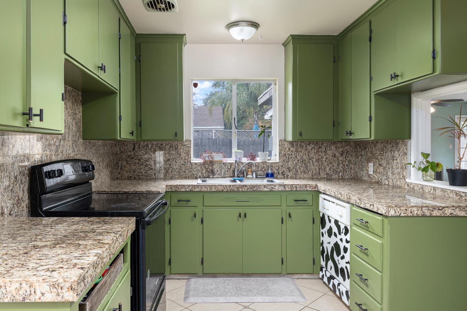 3310 East Hampton Way Fresno, CA 93726 - Photo 8 of 20 a kitchen with a sink a counter top space cabinets and a sink