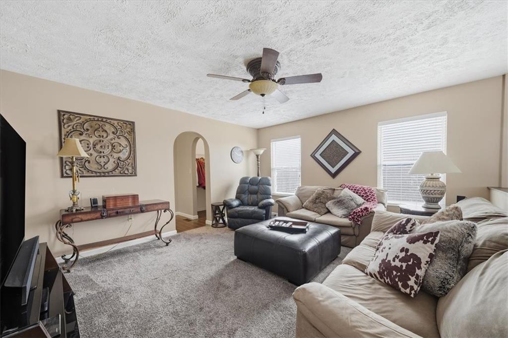 140 Cedar Ridge Drive Monaca, PA 15061 - Photo 18 of 32 a living room with furniture ceiling fan and a window