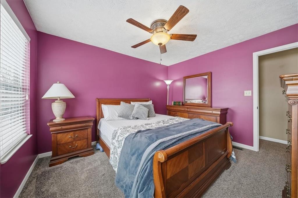 140 Cedar Ridge Drive Monaca, PA 15061 - Photo 23 of 32 a bedroom with a bed and a chandelier