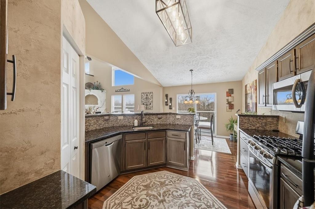 140 Cedar Ridge Drive Monaca, PA 15061 - Photo 10 of 32 a kitchen with stainless steel appliances granite countertop a stove a sink dishwasher and a refrigerator
