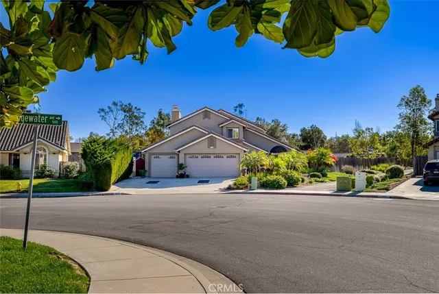 a front view of a house with a yard and outdoor seating
