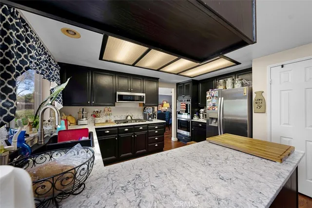 a living room with furniture a bookshelf and a window