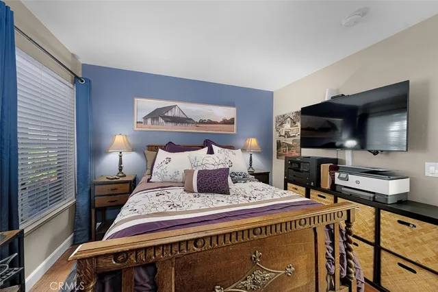 a bedroom with a bed and a flat screen tv