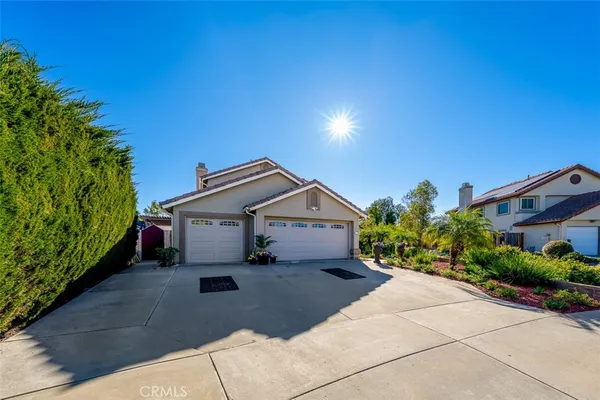a front view of a house with a yard and a garage