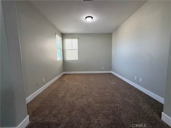 an empty room with a empty space and windows