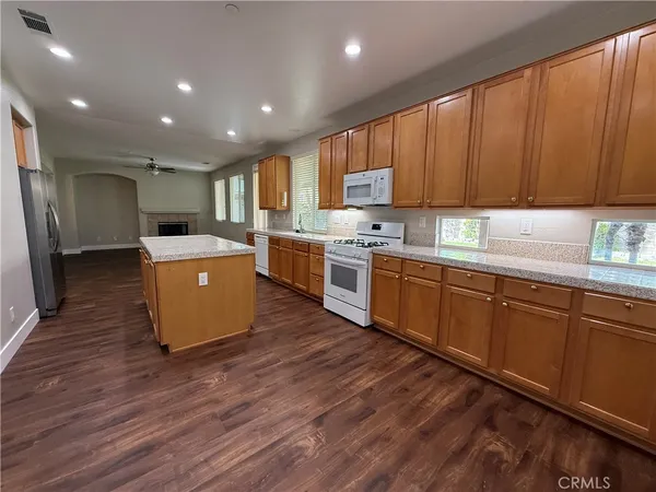 a kitchen with a stove sink and cabinets