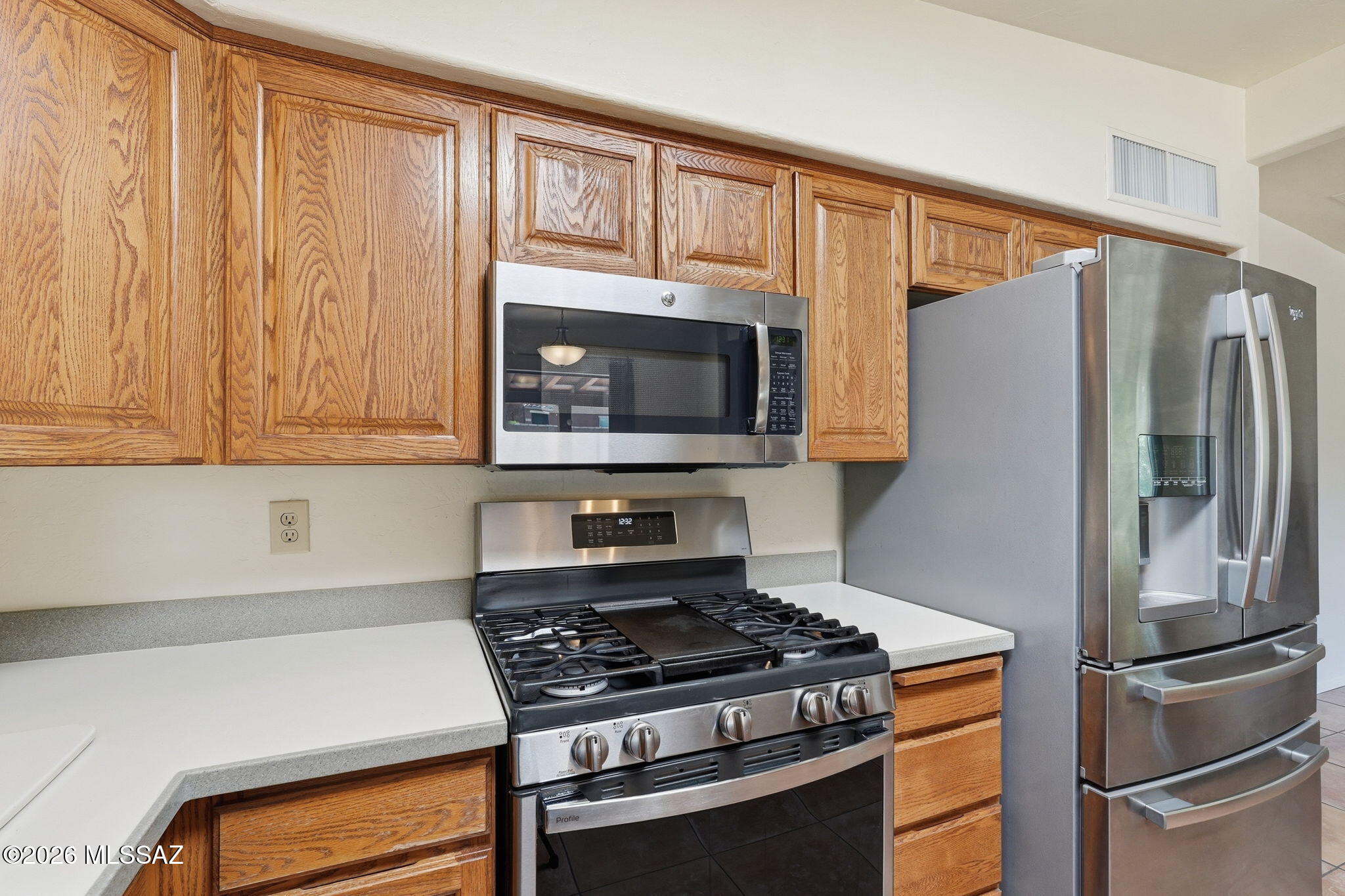 1125 East Kleindale Road Tucson, AZ 85719 - Photo 10 of 49 a kitchen with stainless steel appliances granite countertop a refrigerator stove and microwave