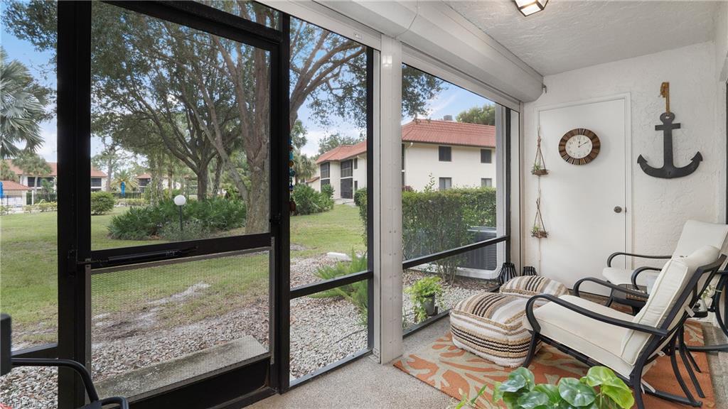 4957 Pepper Circle, Unit C104 Naples, FL 34113 - Photo 15 of 22 Screened lanai with storage closet