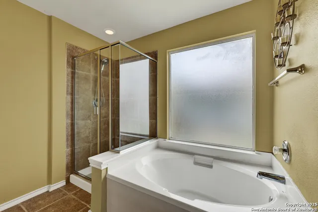 a bathroom with a tub and shower