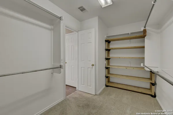 a view of an empty walk in closet