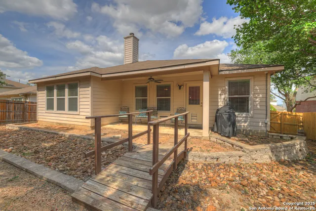 a view of a house with backyard and sitting area