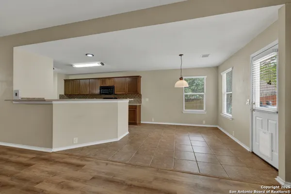 a view of a kitchen with a sink microwave and cabinets