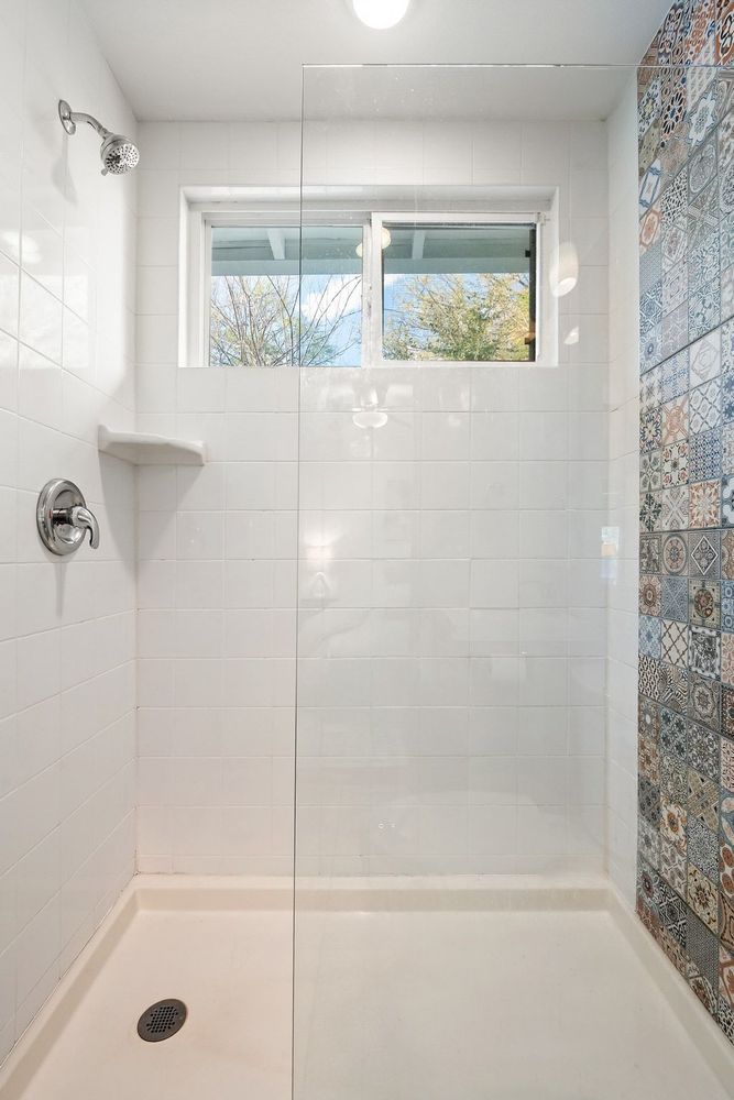 2702 Crest Avenue, Unit 1 Austin, TX 78702 - Photo 22 of 29 The walk-in shower offers a clean, modern design and a comfortable space for everyday use.