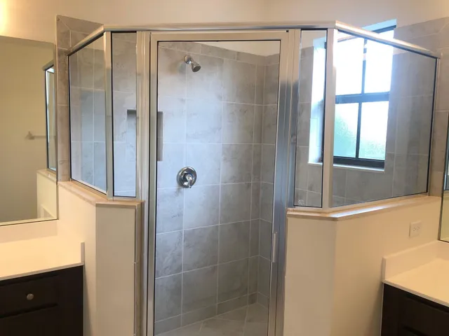 a bathroom with a shower and a sink