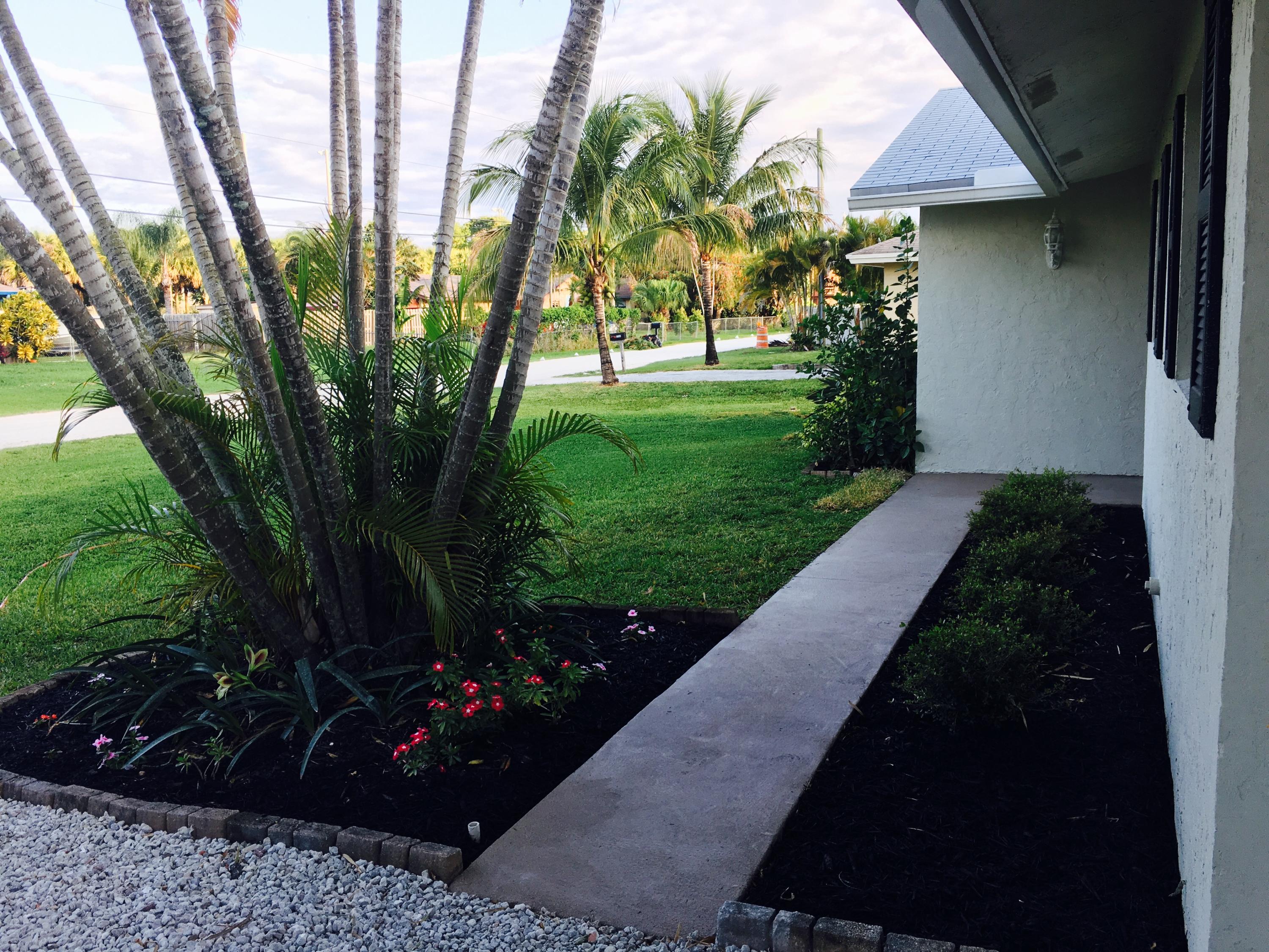 6714 Rigger Road Lake Worth, FL 33462 - Photo 8 of 26 Front manicured lawn and pathway