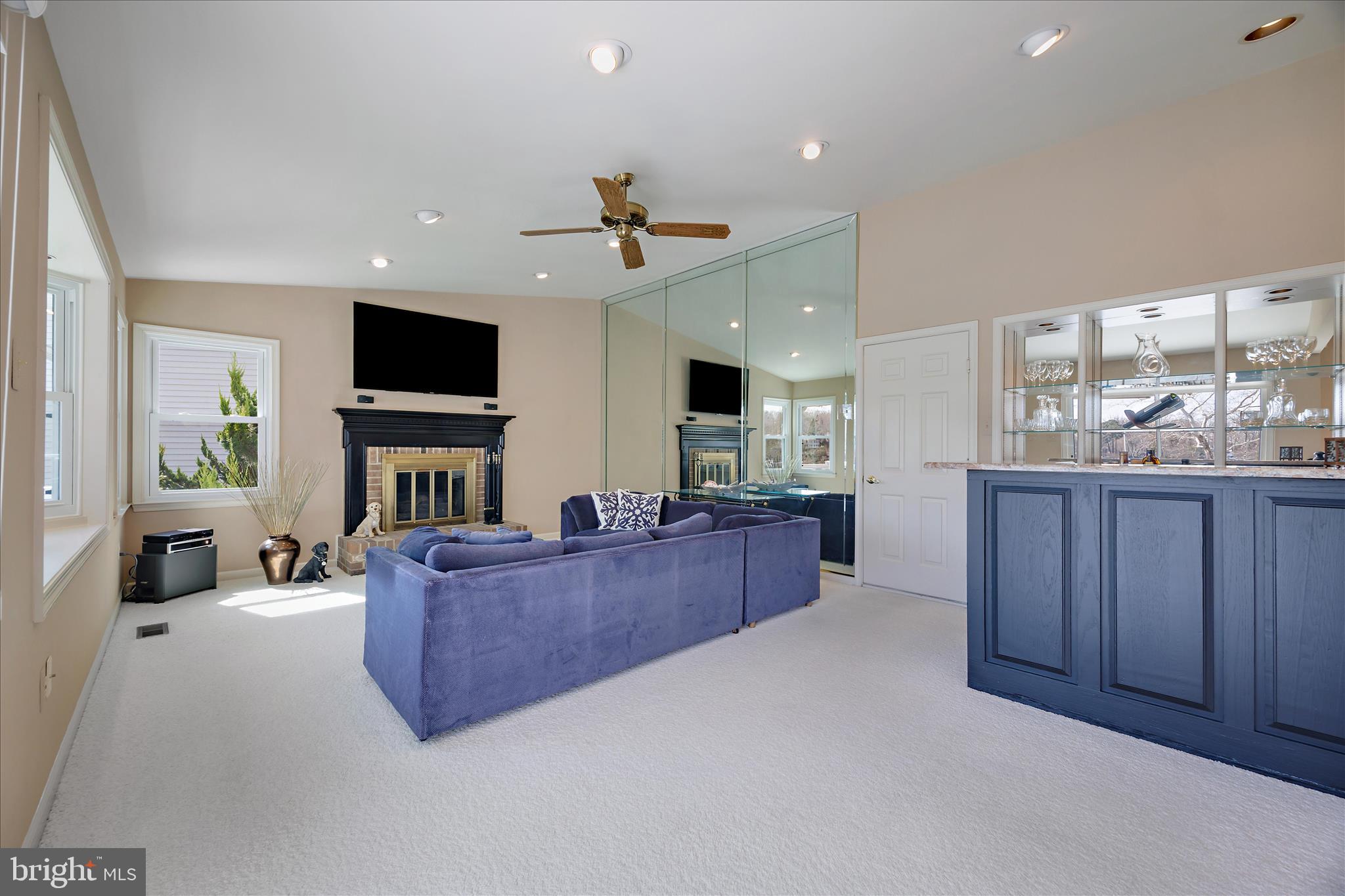 253 Milthorn Court Riva, MD 21140 - Photo 23 of 71 a living room with furniture a fireplace and a flat screen tv