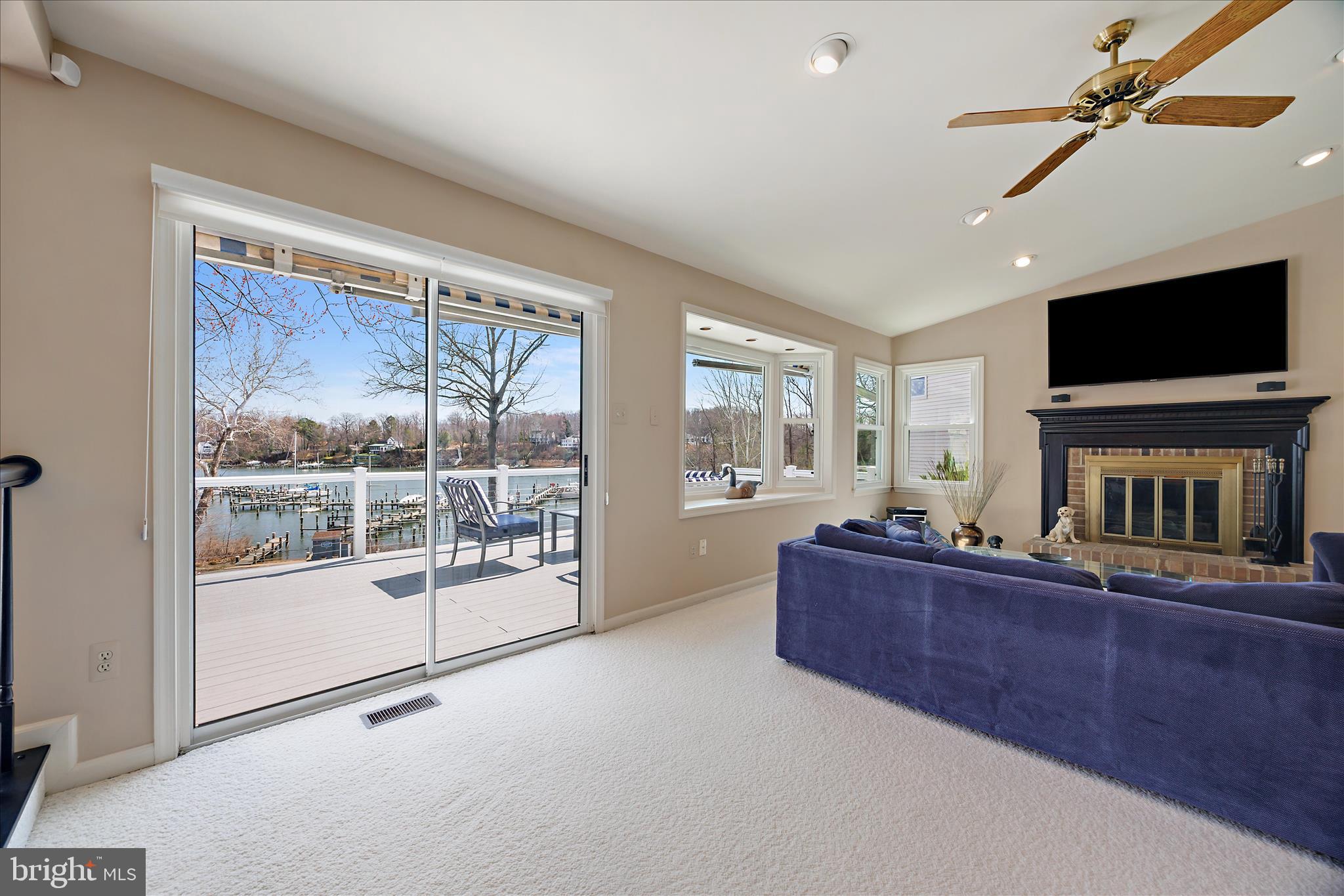 253 Milthorn Court Riva, MD 21140 - Photo 26 of 71 a living room with furniture a flat screen tv and a fireplace