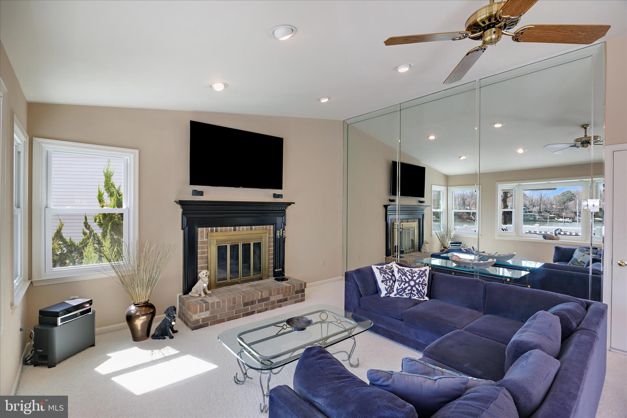 253 Milthorn Court Riva, MD 21140 - Photo 28 of 71 a living room with furniture a fireplace and a flat screen tv