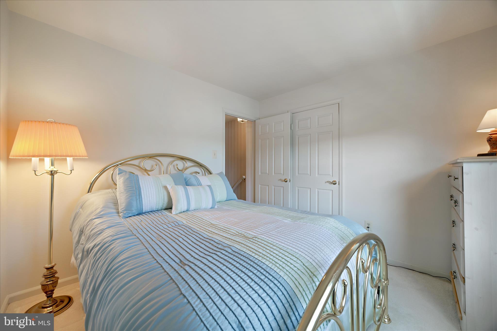 253 Milthorn Court Riva, MD 21140 - Photo 40 of 71 a bedroom with a bed and a lamp