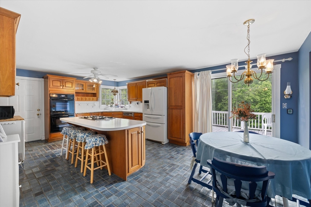40 North Fitzwilliam Road Royalston, MA 01368 - Photo 4 of 42 a kitchen with a table chairs and wooden floor