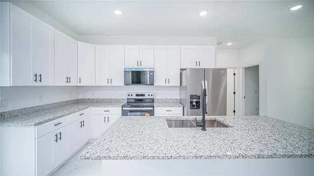 an aerial view of residential house with outdoor space and swimming pool