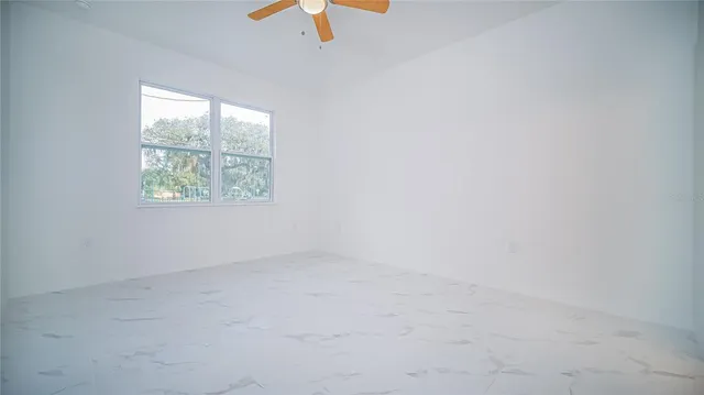 an aerial view of a house with a yard and a fountain