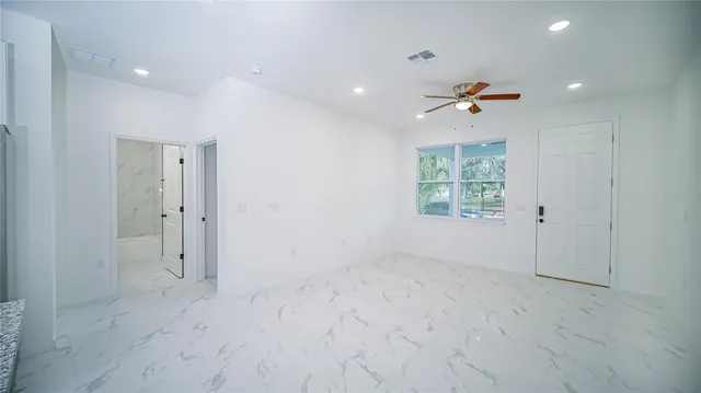 a bedroom with a large bed and a window