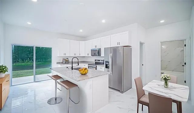 a bathroom with a granite countertop sink a toilet and shower