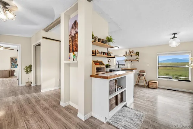 a kitchen with stainless steel appliances a stove and a wooden floor