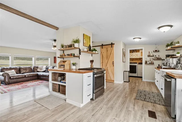 a kitchen with stainless steel appliances granite countertop a stove and cabinets