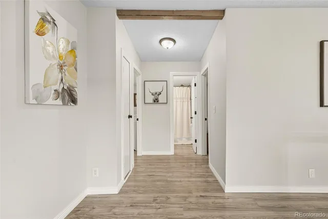 a view of hallway with wooden floor