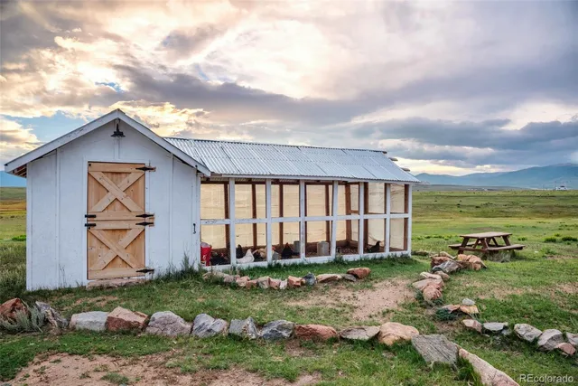a view of a house with backyard and sitting area