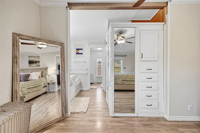a view of a hallway with wooden floor and closet