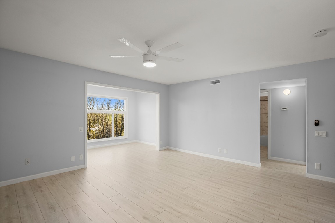 620 South 1st Street, Unit 315 Austin, TX 78704 - Photo 4 of 17 a view of an empty room with a window and wooden floor