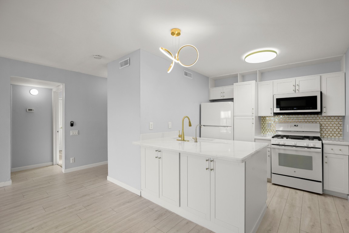620 South 1st Street, Unit 315 Austin, TX 78704 - Photo 5 of 17 a kitchen with cabinets a sink and stainless steel appliances