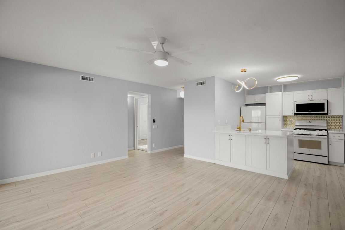 620 South 1st Street, Unit 315 Austin, TX 78704 - Photo 17 of 17 a view of kitchen with wooden floor and electronic appliances