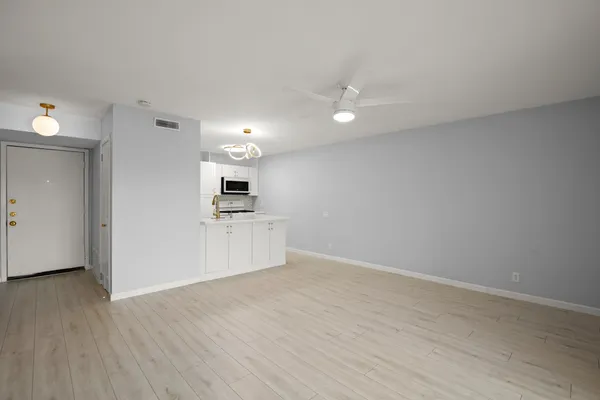 a view of kitchen with wooden floor and electronic appliances