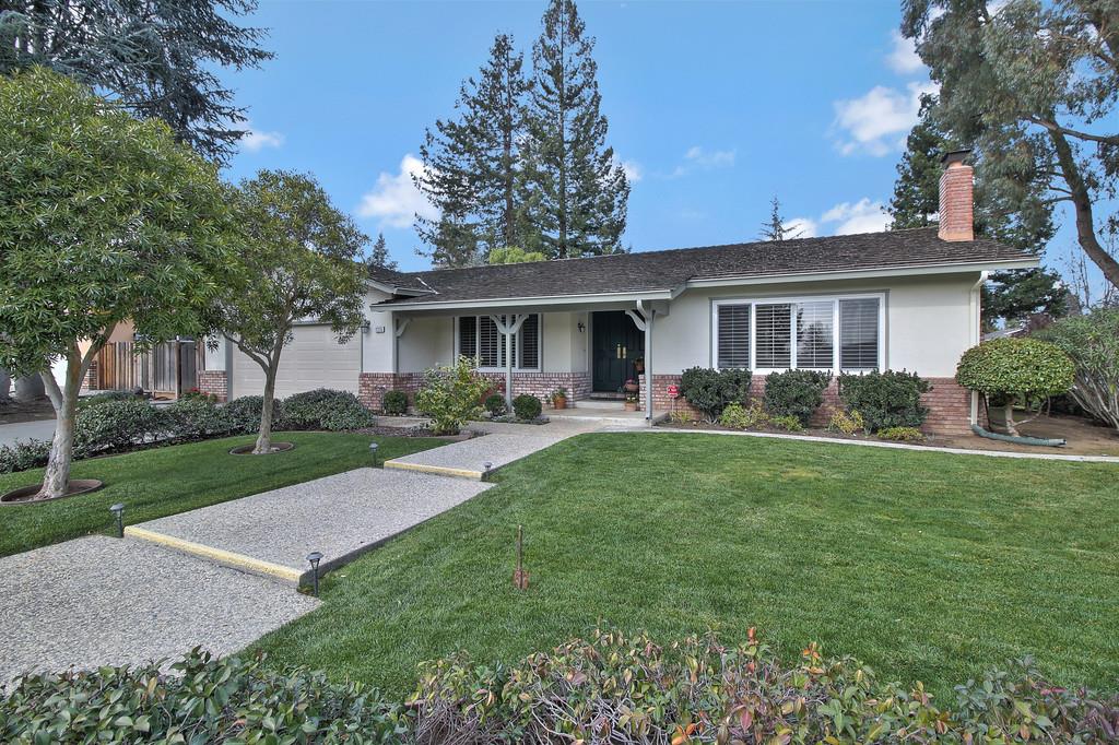 a view of a house with a backyard and a patio
