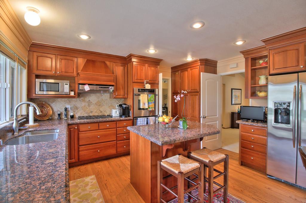 1115 Covington Road Los Altos, CA 94024 - Photo 22 of 39 a large kitchen with granite countertop lots of counter top space