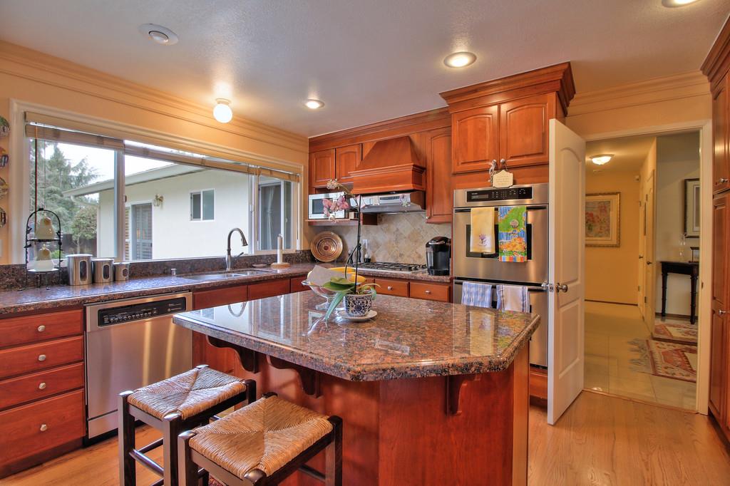 1115 Covington Road Los Altos, CA 94024 - Photo 23 of 39 a kitchen with a table chairs sink and cabinets