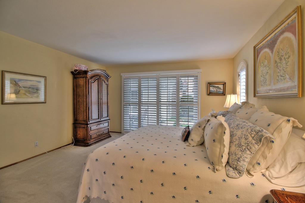 1115 Covington Road Los Altos, CA 94024 - Photo 32 of 39 a bedroom with a bed a window and painting on the wall