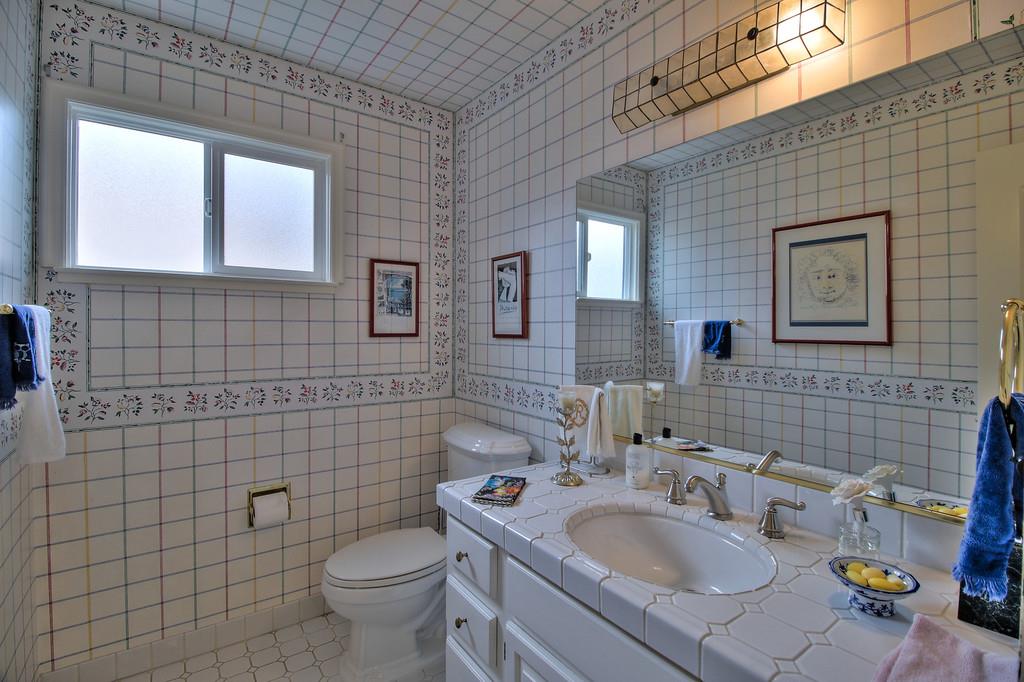 1115 Covington Road Los Altos, CA 94024 - Photo 33 of 39 a bathroom with a sink mirror toilet and shower