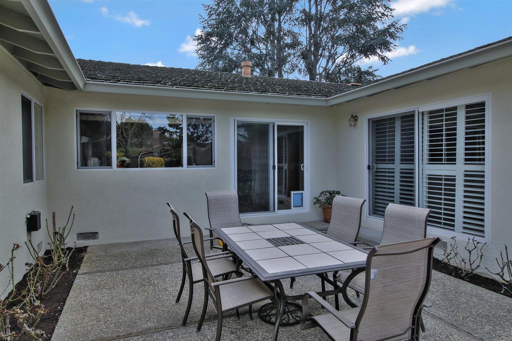 1115 Covington Road Los Altos, CA 94024 - Photo 5 of 39 a patio with a table and chairs and potted plants