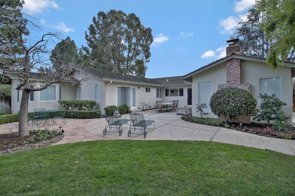 1115 Covington Road Los Altos, CA 94024 - Photo 7 of 39 a view of a patio with table and chairs under an umbrella