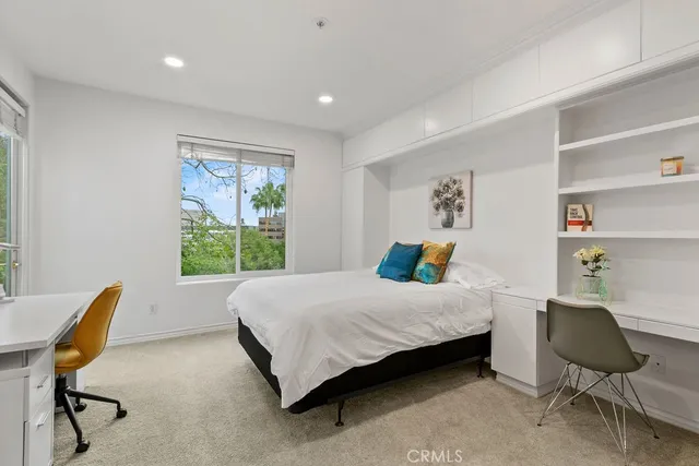 a bedroom with a bed chair and a window